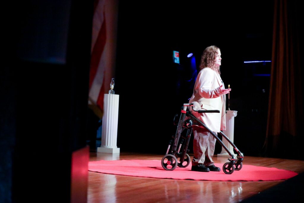 Carly Webster, Founder of DisabledSOS talking on stage as part of her Ted Talk
